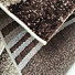 Enigma New / 307-76 Brown-beige - detail povrchu, podkladu a obšití v pohybu